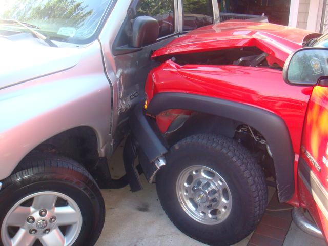 Driver of a landscaping truck plows into parked cars in driveway